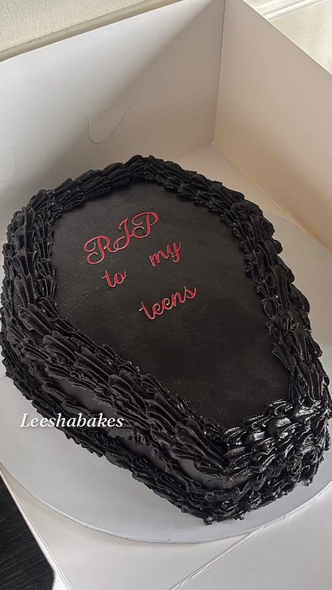 Black coffin-shaped cake with red 'RIP to my teens' message and piped black borders